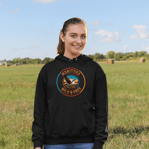 Celebrate the heart of the prairies with our Manitoba – Wild & Free hoodie, featuring a stunning graphic of a Canadian goose soaring over golden wheat fields.